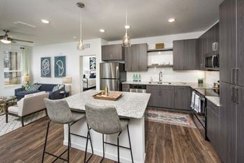 Contemporary cabinetry, tile backsplash and granite countertops in two color schemes